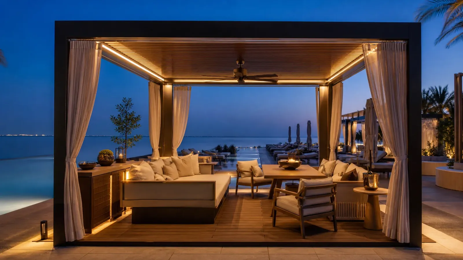 UAE beach club VIP super-cabana at blue hour with integrated lighting, daybed, lounge seating, dining table, storage, and service space