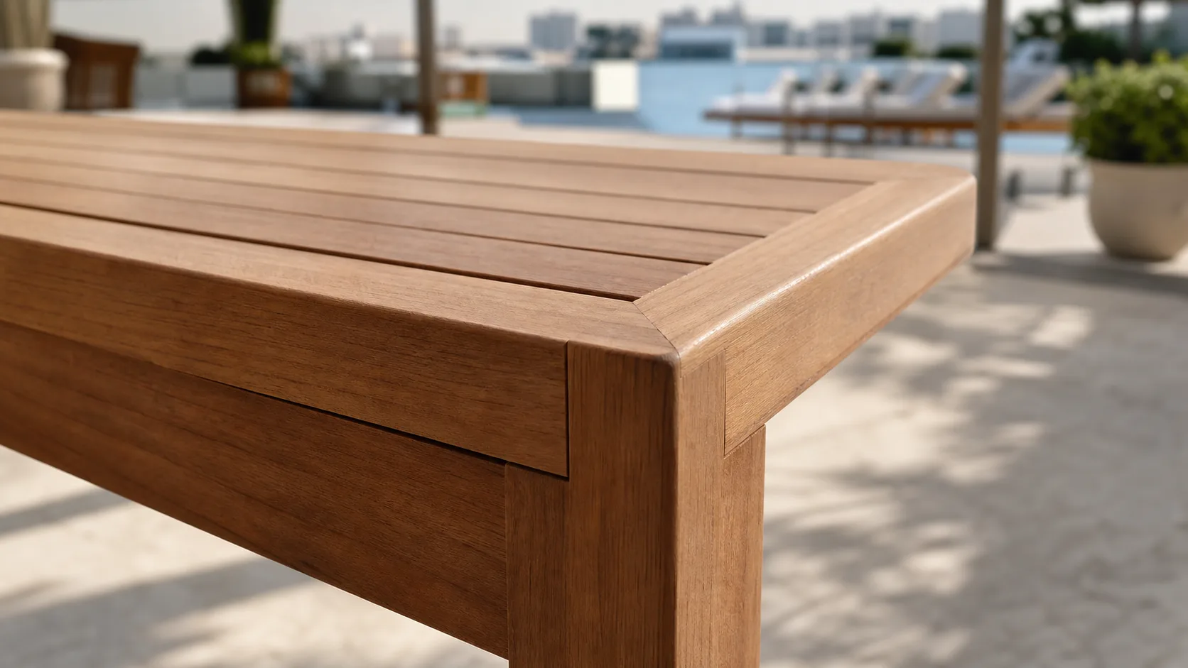 Close detail of teak joinery, rounded edges, and slat spacing on an outdoor table