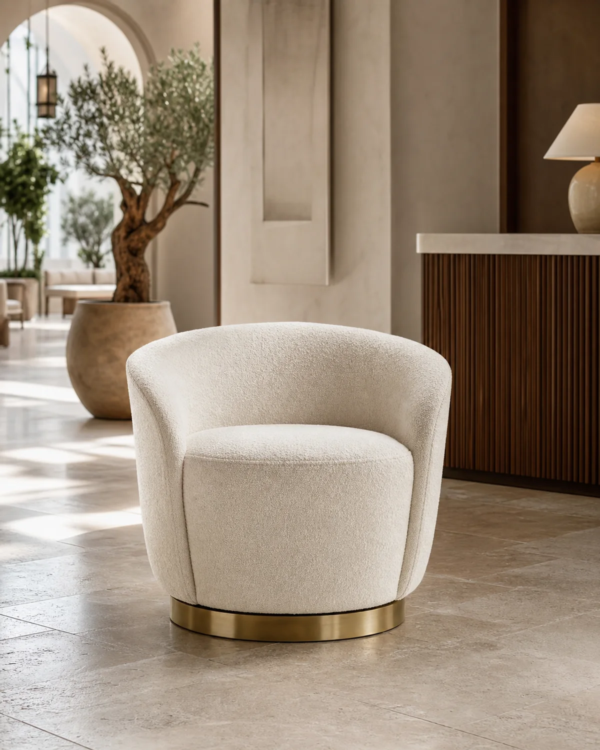 Olea ivory swivel chair with a slim aged-bronze base