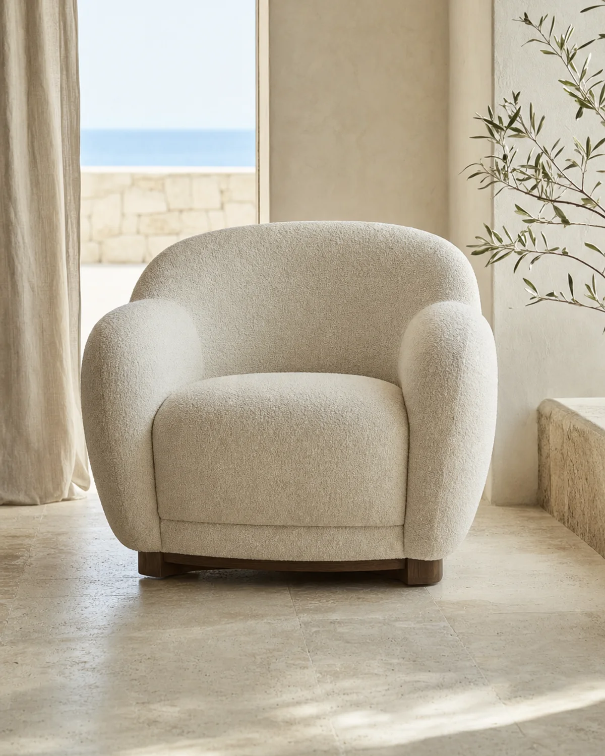 Dune lounge chair with rounded arms and warm ivory upholstery