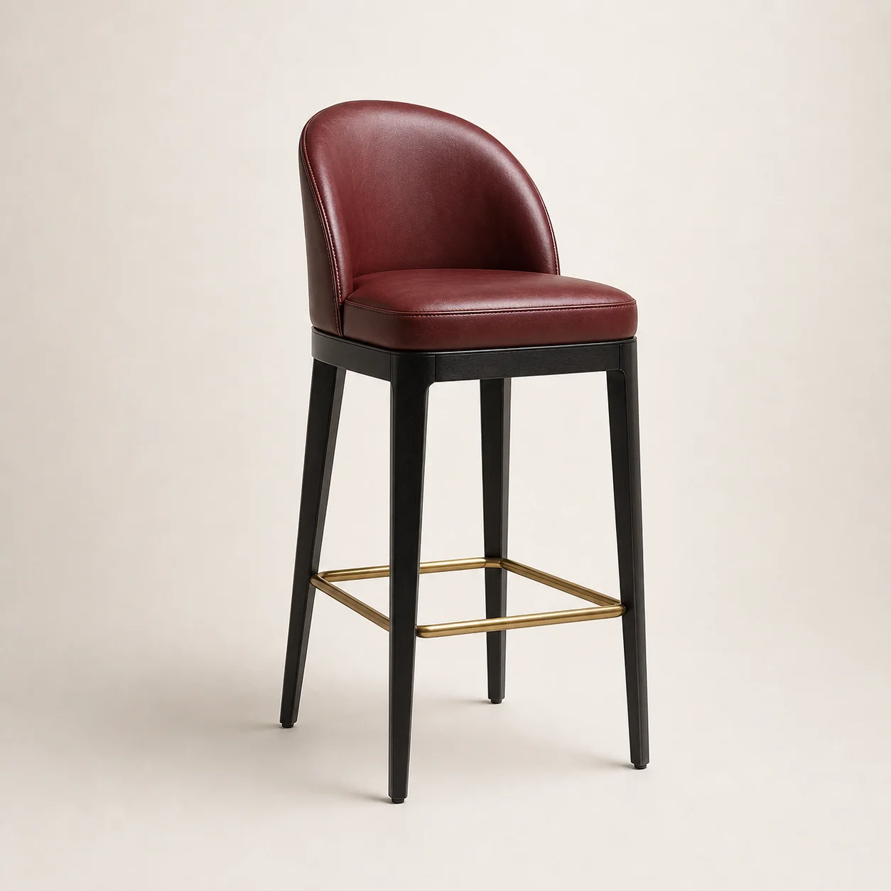 Cadence Bar Stool studio concept visual in oxblood leather, black frame, satin brass