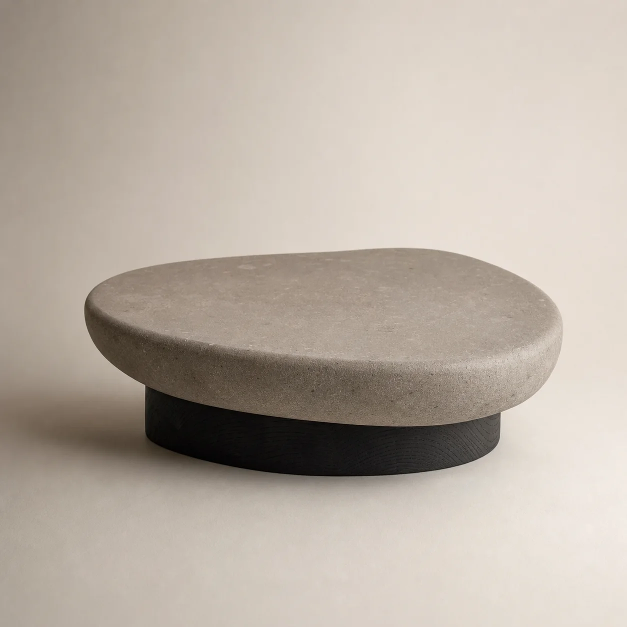 Pebble Tea Table studio concept visual in warm-grey stone, charcoal timber