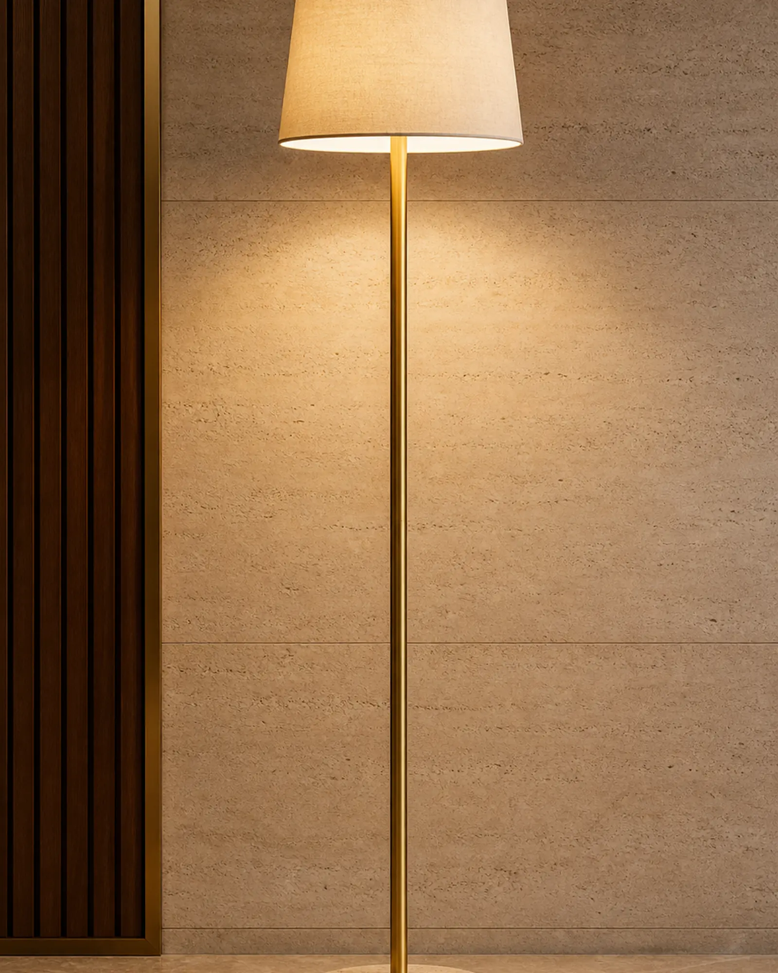 Floor Lamp profile - Slim brass floor lamp beside a lounge chair in a hotel suite