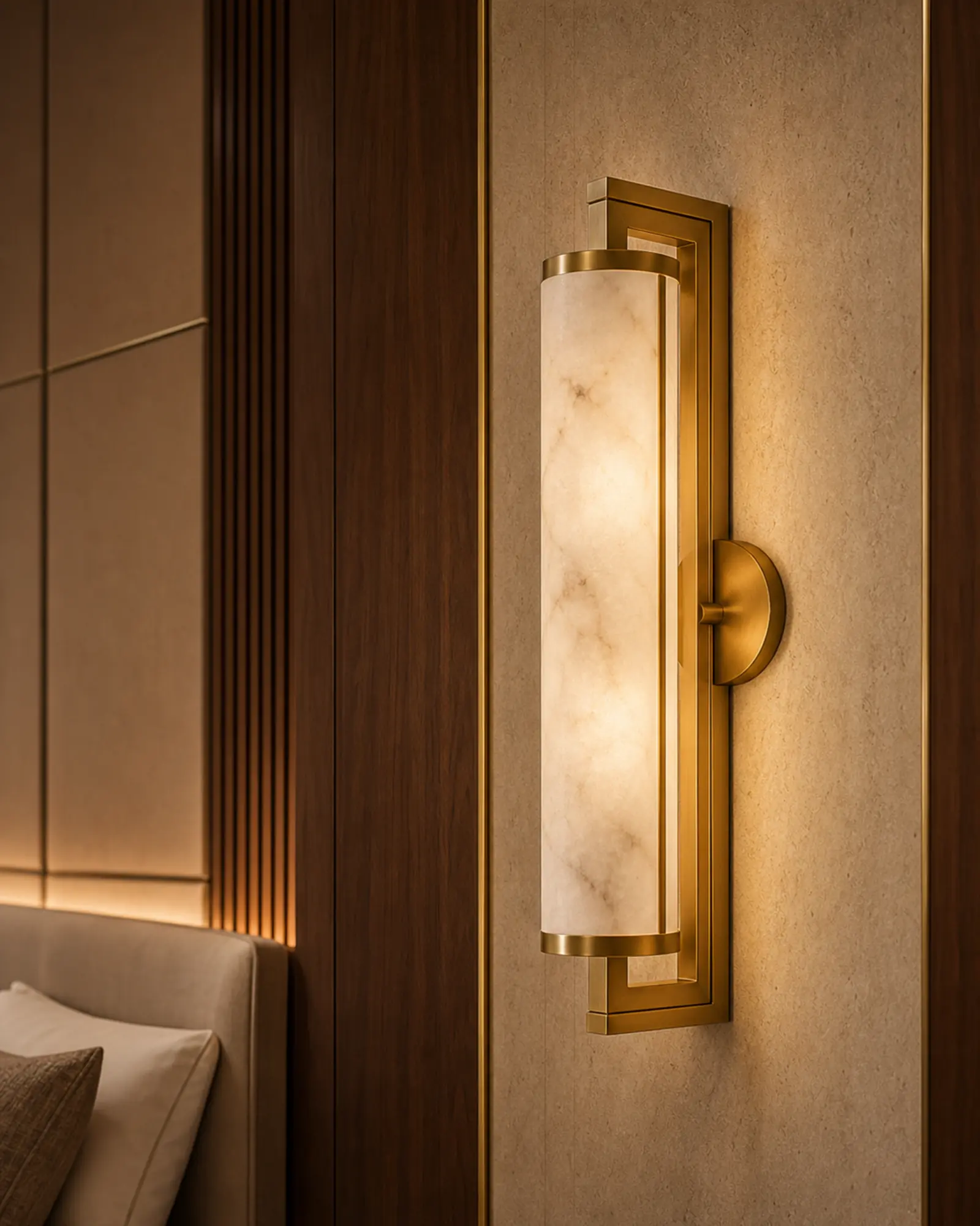 Brass wall sconce with frosted diffuser on a walnut hotel wall panel