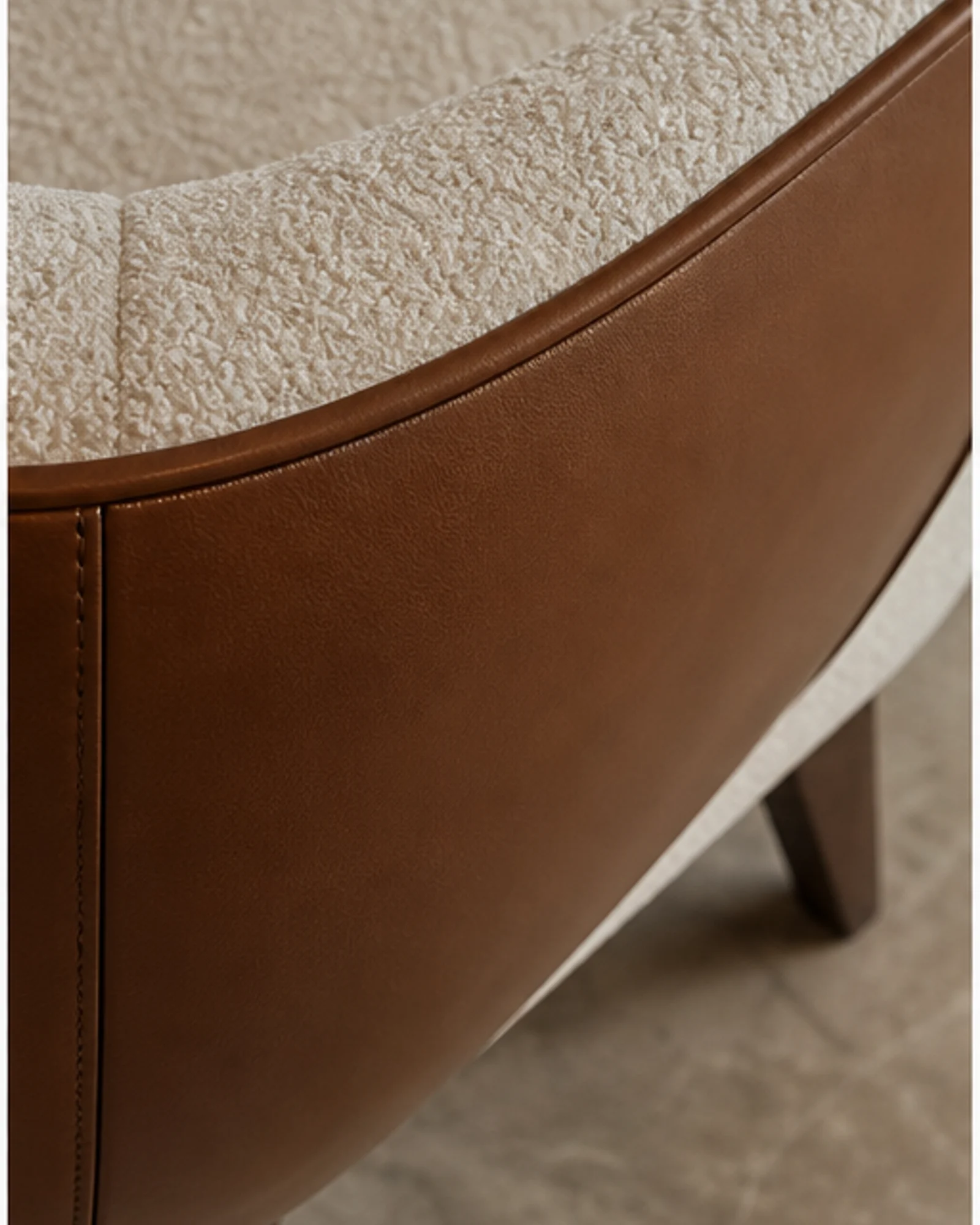 Tailored Lounge Armchair detail view - Sculptural upholstered lounge armchair in a refined hotel lobby setting