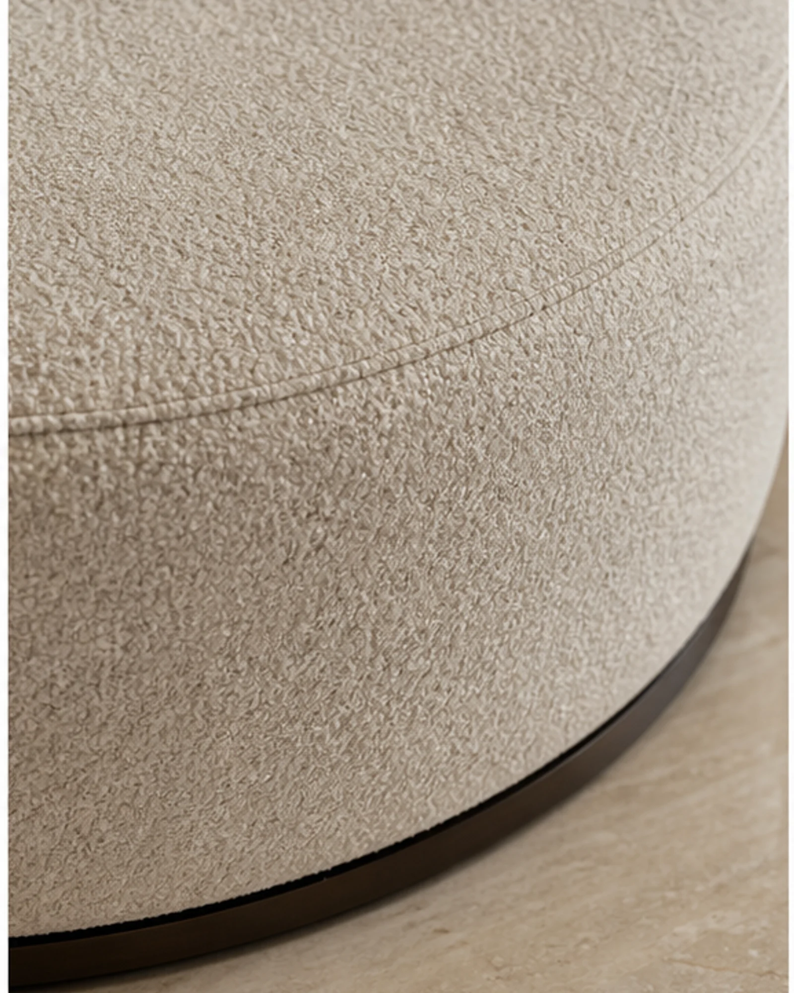 Tailored Lounge Ottoman detail view - Tailored upholstered ottoman in a warm neutral hotel lounge