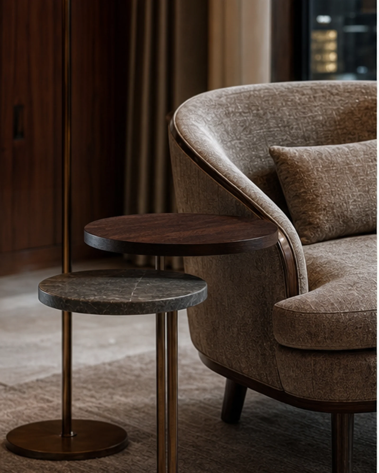 Elegant nesting side tables beside lounge seating in a luxury interior